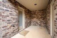 Covered porch between garage and backdoor entry to home