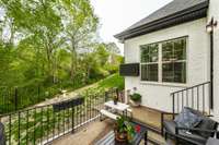 Patio overlooks the backyard and adjacent woods.