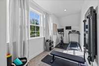 This room is located upstairs. It’s not a bedroom but is an extra large space for you to put your gym, office or extra storage. These windows look out to the front of the house.