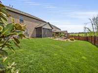 Professionally landscaped yard with additional flagstone patio