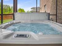 Enjoy your luxury saltwater hot tub in the screened in covered back porch