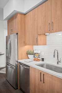 Warm Finish Package Kitchen featuring Italian soft-close cabinets, quartz countertops and stainless steel appliance.