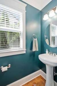 This adorable powder room is on main level off central hallway between living room and family room.