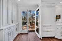 Doors to patio, built in coffee bar with retractable cabinetry