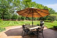 Notice the dense landscaping and a tree line at the back of the property.