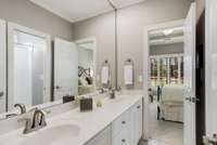 Secondary bathroom with dual vanities.