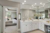 Dual vanities with a makeup area, ceiling height mirrors, and lots of great natural light.