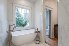 Wet room contains both a free standing tub and large walk in shower