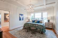 Master bedroom with ceiling detail trim and lots of natural light. King size bed in the photo with large nightstands