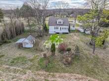 Potting shed to the left, well house to the right, just behind the garage. We do not know if the well house functions