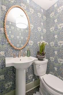 Half bath has William Morris wallpaper and is a new addition to the house