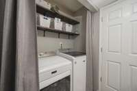 Laundry area with shelving.  Washer and dryer are negotiable.