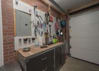 Work bench in garage will remain.  Notice new insulated garage door.