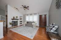 Living room features an attractive fireplace with gas logs and built in book shelves.