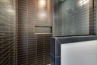 Black tiled shower in Bathroom 1