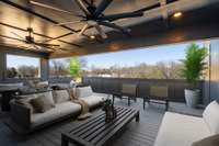 Rooftop deck with dining, seating area ready for football season.