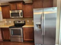 Stainless Side by Side Refrigerator remains with home.