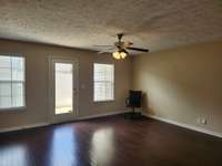 Spacious Living Room with Hardwood Floors and Extra Windows for Natural Light.