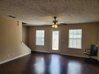 Beautiful Hardwood Floors and Ceiling Fan in Living Room.