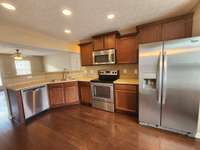 Large Kitchen with Extra Cabinets and Stainless Appliances.