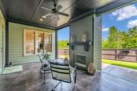 Covered patio with fireplace and private yard