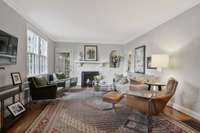 Another view of the living room with a much-loved gas fireplace, and entry door to the second level of the home.