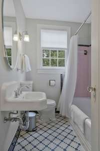 Second Level Full Bathroom with the original tile floors and tub/shower combination!