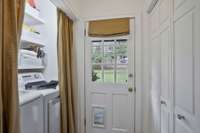 Laundry Room right off the kitchen with Built-in shelves and backyard views!