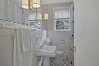 First Floor Full Bath with original tile floor, surround, and tub/shower combination!