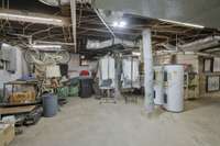 Another View of the expansive basement space.Twin 50-gallon hot water heaters, as one empties it's filled by the other.