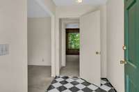 Entry foyer leads to the formal living room on the left and den straight ahead.