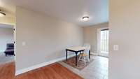 The dining area is nestled nicely between the kitchen and living space.