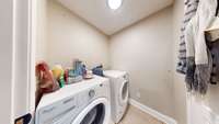 The laundry room is accessible from the kitchen and also from the primary bedroom.