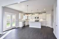 Open concept with kitchen and casual dining. Photo not of actual home.