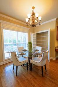 The breakfast area, flooded with light, adjoins a spacious pantry closet, ensuring easy access to kitchen essentials.