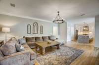 Family room off kitchen with two-sided fireplace next to Florida sun room.