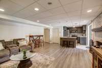 Lower level living area with fireplace and full kitchen.