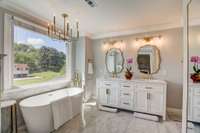 Primary bathroom up with walk in stand in shower and soaking tub.