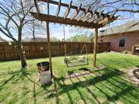 Relaxing swing in fenced back yard