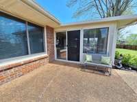 Florida / Sunroom with large patio behind fenced back yard