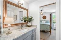 Secondary bathroom is fresh and modern. This space connects directly to the hallway and the bedroom.