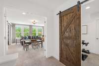 Bonus room with double doors + an exercise area with a barn door.