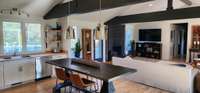 Sleek kitchen: open shelving, large island. Streamlined design for practicality and sophistication.