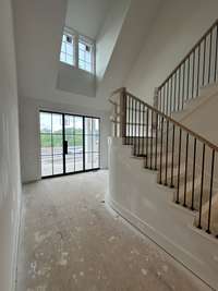 Spacious Two-story Foyer and Staircase with Black Square Iron Spindles w/ White Oak Newels and Handrail Built By: Insignia Homes *this home is under construction.  Photo taken - 5/4/24