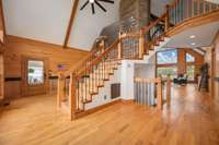 Floor to ceiling rock fireplace and gleaming hardwood floors.