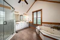 Even the primary bath is vaulted! Huge shower, separate soaking tub, tile floor, double vanity, and views for days!