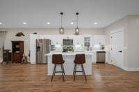 The kitchen is well appointed with an island, window over the sink, stainless appliances, pantry and under cabinet lighting.