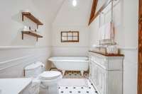 Efficiency apartment bathroom with footed tub.