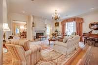 Large living room with hardwood floors and fireplace.