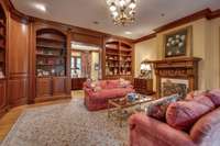 Rest and Relax in this beautiful library offering a cozy gas log fireplace,and  lots of built in shelving for your favorite books.